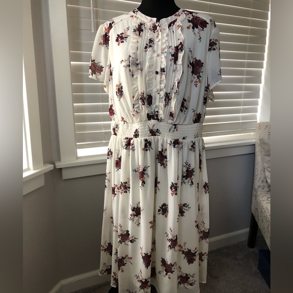 Floral print button detail midi dress. Smocked waist short sleeves.